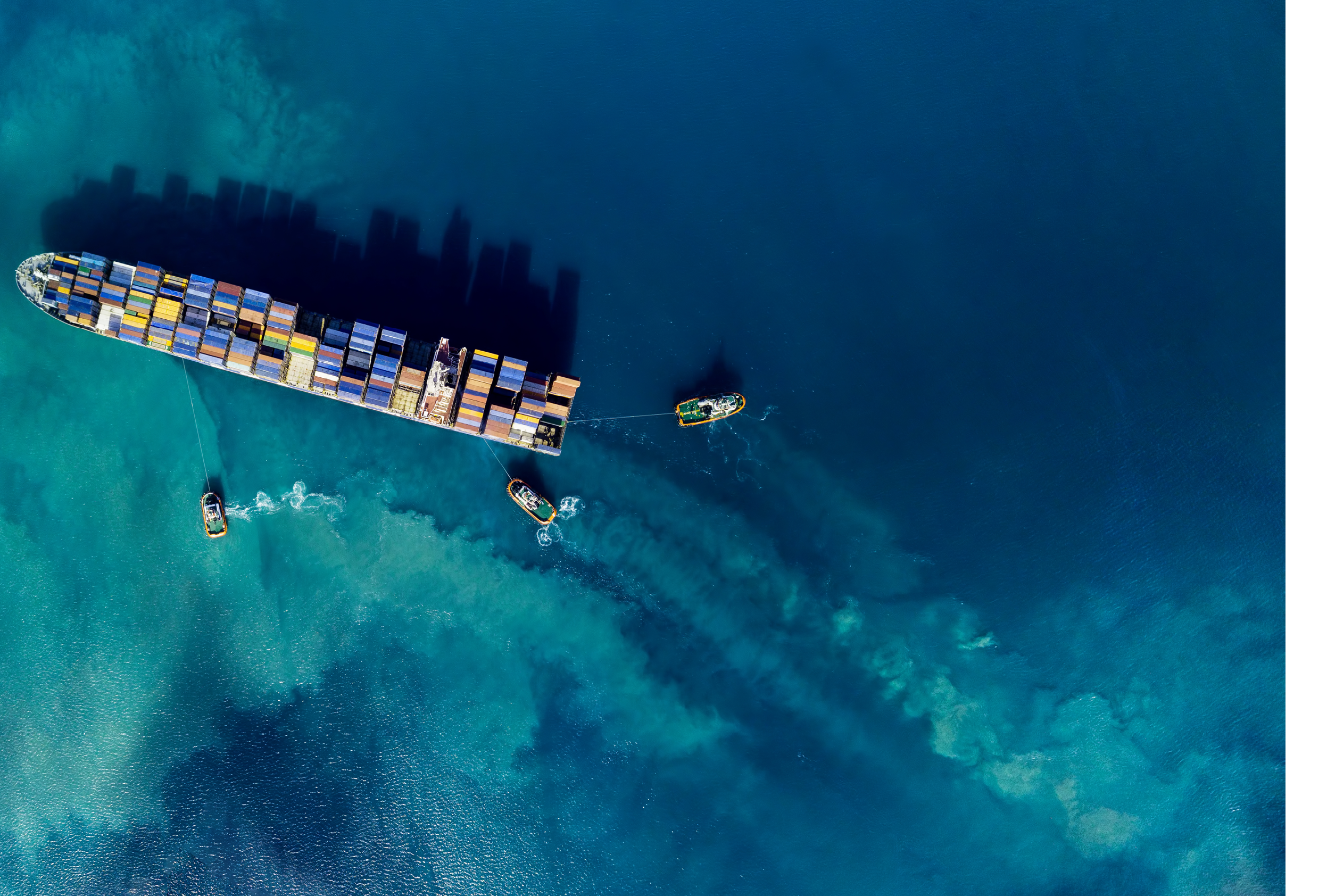 Aerial shoot of a cargo ship mooring in a harbour