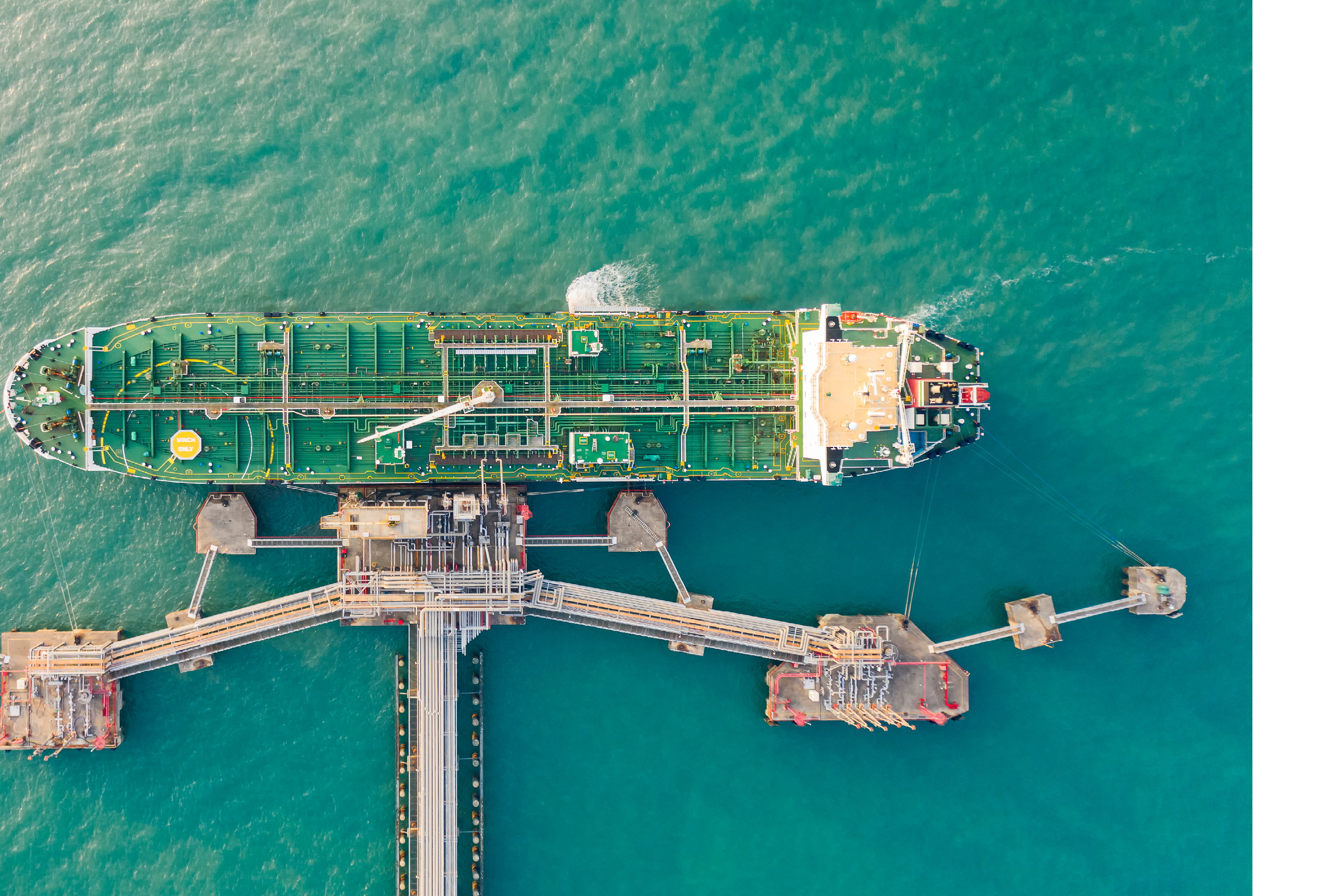 Aerial top view Oil ship tanker load or unload oil at loading dock from refinery for transportation on the sea.